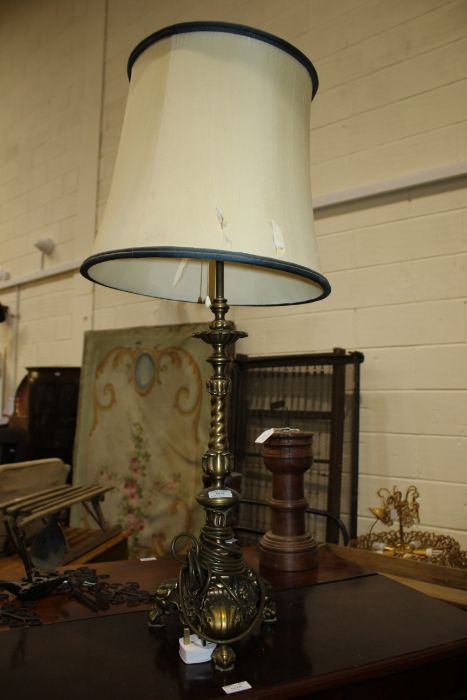 A gilt metal rococo style lamp, the central pillar with a tulip and twist design going down to a