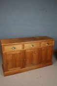 20th century pine sideboard, the rectangular top above three drawers with brass handles above