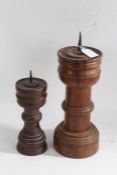 Two turned oak pricket candlesticks, the smallest in the Gothic taste with stepped base, 25cm