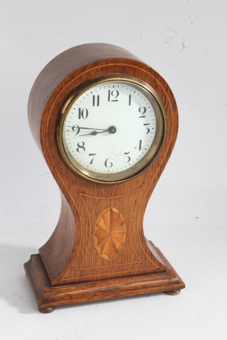 Edwardian oak and fan marquetry inlaid mantel clock, the white enamel dial with  Arabic numerals,