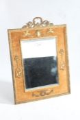 20th century gilt and velvet mirror, with a gilt floral pediment above a pair of putti/cherubs