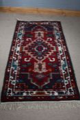 20th century Moroccan style rug, with a red and dark blue ground together with a geometric central