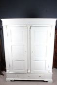 Continental white painted pine knockdown wardrobe, possibly German or Danish, the pair of bowed