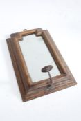 17th century style oak wall mirror, the shaped mirror plate housed in a stepped frame with iron