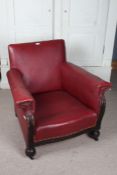 1920's armchair, upholstered in red leatherette, raised on bun feet and castors