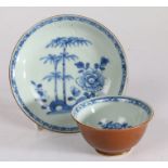 18th Century Nanking Cargo blue and white tea bowl and saucer, circa 1752, decorated with trees,