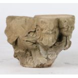 A limestone capital, probably 13th century Designed with a grotesque 'lion' mask issuing acanthus