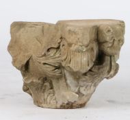 A limestone capital, probably 13th century Designed with a grotesque 'lion' mask issuing acanthus