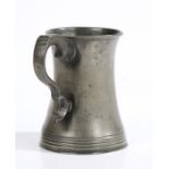 A mid-19th century pewter pint mug, Irish Of waisted form, with multi-reeded base, double scroll