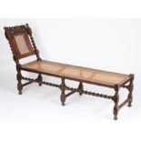 A late 17th century walnut and cane day bed, English, circa 1685 With typical raked chair-back to