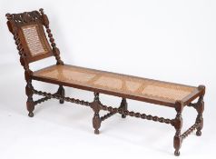 A late 17th century walnut and cane day bed, English, circa 1685 With typical raked chair-back to