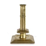 A rare and fine Charles II brass cluster-stem socket candlestick, circa 1680 The cast square stem