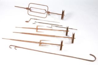 A group of 18th/19th century iron spit rods/bars With typical spoke-wheel ends, longest 110cm