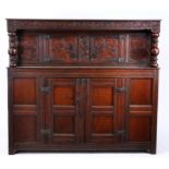 A Charles II oak court cupboard, Yorkshire, circa 1680 The rectangular top above a scroll-carved