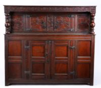 A Charles II oak court cupboard, Yorkshire, circa 1680 The rectangular top above a scroll-carved