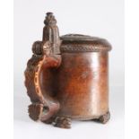 An 18th century burr birch peg tankard, Norwegian, circa 1730-50 The gently domed lid naively carved