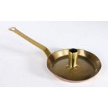 An early 18th century brass chamberstick, English, circa 1700-30 The sheet-brass pan with tapering