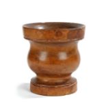 A 19th century maple/sycamore mortar Having a turned baluster body, on a ring turned foot, 16cm
