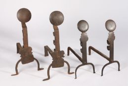 Two pairs of iron andirons or firedogs Each surmounted by a large disc, with height adjustment