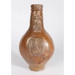 A 17th Century Bellarmine stoneware jug, the reeded lip above a bearded mask and medallion to the