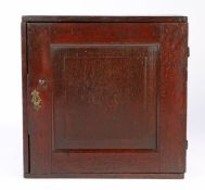 A small Queen Anne joined and boarded oak spice cupboard, circa 1710 The single fielded panelled