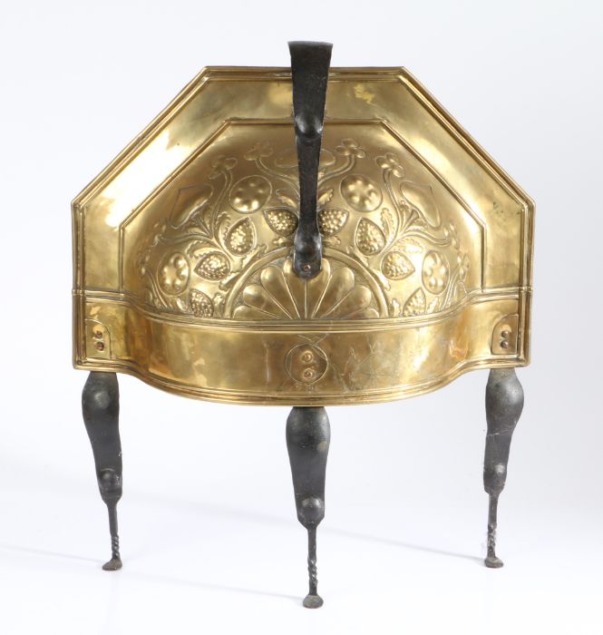 A late 18th century repouseé brass and iron curfew, Dutch Of semi-circular domed form, with loop