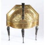A late 18th century repouseé brass and iron curfew, Dutch Of semi-circular domed form, with loop