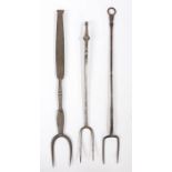 Three 18th century steel cooking forks, English Each with two curved tines, one with a short ball-