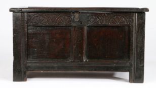 A small Charles I oak coffer, circa 1630 Having a twin-panelled lid and front, the top rail carved