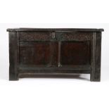 A small Charles I oak coffer, circa 1630 Having a twin-panelled lid and front, the top rail carved