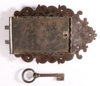 A 17th century steel lock and key Profusely engraved with scrolling foliage, closing with two bolts,