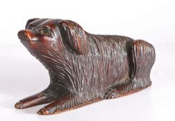 A 19th century walnut model of a full-bodied long haired dog Recumbent, with raised head, carved out