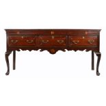 A George III oak and inlaid low dresser, North-West/West Midlands, circa 1780 The top of two wide