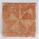 A 14th century floor tile, English Decorated with a geometric design of triangles, 12.3cm square