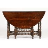 A Charles II oak gateleg dining table, circa 1680 Having an oval drop-leaf top, on ball and fillet-