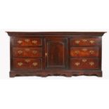 An early George III oak fully enclosed dresser base, circa 1770 Having a twin-boarded top, and