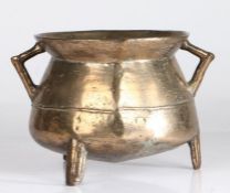 A small 17th century bronze cauldron, English Of typical form, with bag-shaped body, angular
