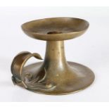 An Arts & Crafts brass chamberstick, circa 1910 Having a large circular dished nozzle, trumpet-