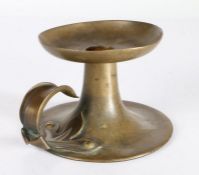 An Arts & Crafts brass chamberstick, circa 1910 Having a large circular dished nozzle, trumpet-