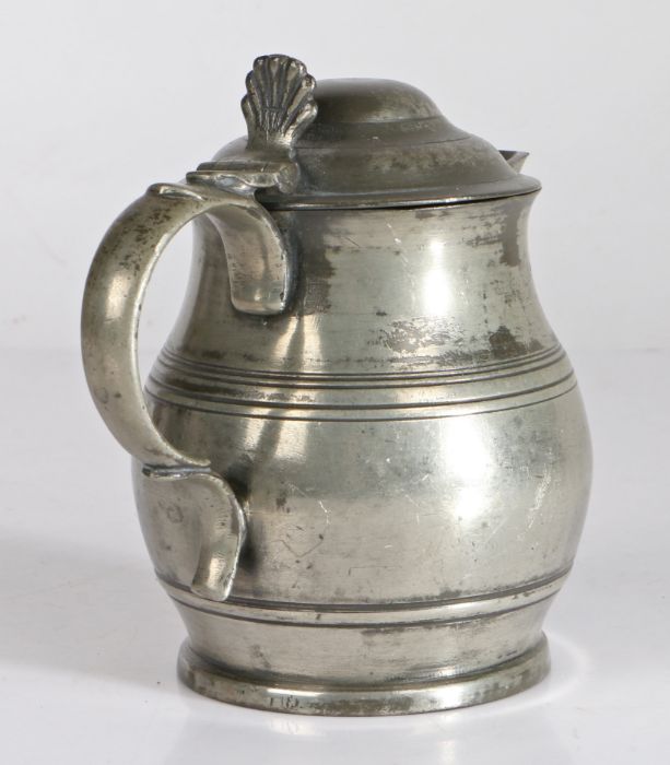 A Victorian pewter Imperial half-pint lidded ale jug,  circa 1850 The spouted bulbous body with