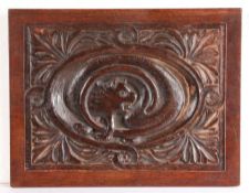 A 19th century oak carved panel, designed with a cat Carved to the centre with the cat chasing its