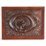 A 19th century oak carved panel, designed with a cat Carved to the centre with the cat chasing its