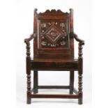 A Charles II oak panel-back open armchair, South Yorkshire, circa 1670 The uprights with inward