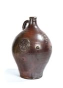 A good 17th century bellarmine stoneware jug, dated 1623 In brown glaze, the bulbous body with three