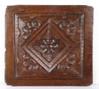 An Elizabeth I carved oak panel, circa 1590 Carved with a central lozenge, with stepped edges,