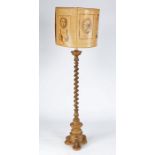 A giltwood standard lamp, having a spiral-turned pillar, on a circular triform base, with shade,