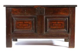 An Elizabeth I oak and inlaid coffer, circa 1580 The hinged lid with two panels, enclosing storage