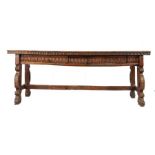 A 17th century walnut long table, Spanish Having a twin-plank top with ovolo-moulded over nulled-