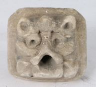 A 14th century limestone ‘Green Man’, possibly English, With cat-like ears, drilled eyes and open-