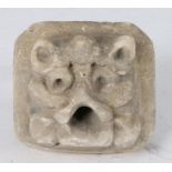 A 14th century limestone ‘Green Man’, possibly English, With cat-like ears, drilled eyes and open-